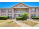 Two-story condo building with brick and light-colored exterior and lush landscaping at 6428 Gloria Dr # 15, New Port Richey, FL 34653