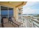Relax on this balcony featuring lounge chairs and stunning water views at 11 San Marco St # 903, Clearwater, FL 33767
