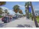 People strolling along a palm tree-lined beachfront walkway at 11 San Marco St # 903, Clearwater, FL 33767
