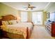 Main bedroom with king bed, ceiling fan, and access to a private balcony at 11 San Marco St # 903, Clearwater, FL 33767