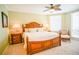 King-size bed, ceiling fan, and private balcony with ocean view at 11 San Marco St # 903, Clearwater, FL 33767