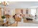 Elegant dining room with glass-top table, chandelier, and hardwood floors at 11 San Marco St # 903, Clearwater, FL 33767