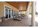 Covered patio with comfortable seating overlooking the pool at 11 San Marco St # 903, Clearwater, FL 33767