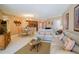 Spacious living room with light beige leather sofas, a glass-top coffee table, and tiled floors at 11 San Marco St # 903, Clearwater, FL 33767