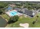 Stunning aerial view showcasing community amenities with large pool, golf course, and neighborhood homes at 10727 Duck Hook Ct, San Antonio, FL 33576