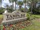 Entrance sign to the Tampa Bay Golf & Country Club surrounded by colorful flowers at 10727 Duck Hook Ct, San Antonio, FL 33576