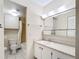 Clean bathroom with shower/tub combo, vanity, and linen closet at 11485 Oakhurst Rd # 107, Largo, FL 33774