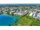 Aerial view showcasing condo community by the lake, ample parking, and landscape at 11485 Oakhurst Rd # 107, Largo, FL 33774
