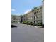 Exterior view of two-story building with parking at 11485 Oakhurst Rd # 107, Largo, FL 33774