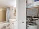 Bathroom with toilet, vanity, and water heater at 11485 Oakhurst Rd # 107, Largo, FL 33774