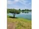 Tranquil lakefront property with a manicured lawn at 11485 Oakhurst Rd # 107, Largo, FL 33774