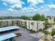 Aerial view of condo building, parking and surrounding area at 11485 Oakhurst Rd # 107, Largo, FL 33774