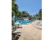 Community swimming pool with lounge chairs and patio tables at 11485 Oakhurst Rd # 107, Largo, FL 33774
