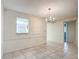 Dining room with tile floors and chandelier at 11485 Oakhurst Rd # 107, Largo, FL 33774