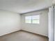 Bright bedroom with window, closet, and neutral carpeting at 11485 Oakhurst Rd # 107, Largo, FL 33774