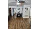 Bright dining area with wood-look floors, a modern chandelier, seating for four, and access to the kitchen at 5347 81St N Ln # 22, St Petersburg, FL 33709