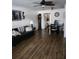 Cozy living room featuring wood-look floors, a ceiling fan, comfortable seating, and an adjacent dining area at 5347 81St N Ln # 22, St Petersburg, FL 33709