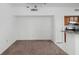 Empty dining area with brown carpet and kitchen access at 10590 Windsor Lake Ct # 0, Tampa, FL 33626