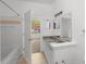 Clean bathroom with granite countertop, single sink and tub at 10590 Windsor Lake Ct # 0, Tampa, FL 33626