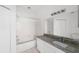 Bathroom with granite countertop, single sink and tub at 10590 Windsor Lake Ct # 0, Tampa, FL 33626