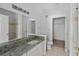 Bathroom with granite countertop, single sink, and tub at 10590 Windsor Lake Ct # 0, Tampa, FL 33626