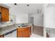 Kitchen with granite countertops, double sink and view into living room at 10590 Windsor Lake Ct # 0, Tampa, FL 33626