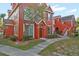 Two-story red building with landscaping and walkway at 10590 Windsor Lake Ct # 0, Tampa, FL 33626