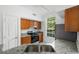 Kitchen with granite counters, wooden cabinets, and appliances at 10590 Windsor Lake Ct # 0, Tampa, FL 33626