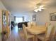 Dining area with a light wood table and chairs, overlooking the living room at 948 Virginia St # 205, Dunedin, FL 34698
