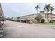 Two-story building with covered parking and lush landscaping at 948 Virginia St # 205, Dunedin, FL 34698