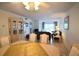 Dining area with a light wood table and chairs, overlooking the living room at 948 Virginia St # 205, Dunedin, FL 34698