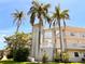 Condo building exterior with palm trees and building number L-948 at 948 Virginia St # 205, Dunedin, FL 34698