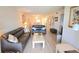 Living Room with gray leather couches, and light wood flooring at 948 Virginia St # 205, Dunedin, FL 34698