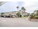 Two-story building with covered parking and lush landscaping at 948 Virginia St # 205, Dunedin, FL 34698