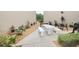 Community patio with stone table, benches, and lush landscaping at 948 Virginia St # 205, Dunedin, FL 34698
