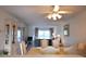Dining area with a light wood table and chairs, overlooking the living room at 948 Virginia St # 205, Dunedin, FL 34698