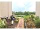 Private backyard oasis with brick path leading to a tranquil lake view at 948 Virginia St # 205, Dunedin, FL 34698