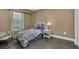 Cozy bedroom with floral bedding and a window with blinds at 6226 Anhinga Pl, Tampa, FL 33615