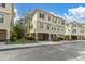 Street view of tan three-story townhomes in a neighborhood at 6226 Anhinga Pl, Tampa, FL 33615
