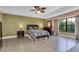 Large bedroom with hardwood floors, ceiling fan, and large windows at 6226 Anhinga Pl, Tampa, FL 33615