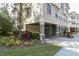 Exterior view of tan three-story townhome with landscaping at 6226 Anhinga Pl, Tampa, FL 33615