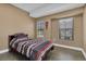 Simple bedroom with striped bedding and plenty of natural light at 6226 Anhinga Pl, Tampa, FL 33615