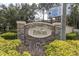 Stone and brick Pelican Pointe entrance sign with landscaping at 6226 Anhinga Pl, Tampa, FL 33615