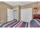 Well-lit bedroom with a double door closet and wood flooring at 6226 Anhinga Pl, Tampa, FL 33615