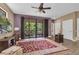 Living room with hardwood floors, sliding glass doors to patio, and large TV at 6226 Anhinga Pl, Tampa, FL 33615