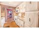 Bright kitchen with white cabinets, granite countertops, and appliances at 5347 81St N Ln # 22, St Petersburg, FL 33709
