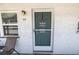 Unit exterior with teal door and small patio at 5347 81St N Ln # 22, St Petersburg, FL 33709