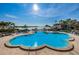 Large, freeform pool with plenty of lounge chairs and water views at 5130 Brittany S Dr # 202, St Petersburg, FL 33715