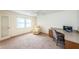 Bright home office features built-in desk, comfortable chair, and large window at 5130 Brittany S Dr # 202, St Petersburg, FL 33715