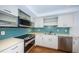 Updated kitchen with stainless steel appliances and teal backsplash at 5130 Brittany S Dr # 202, St Petersburg, FL 33715